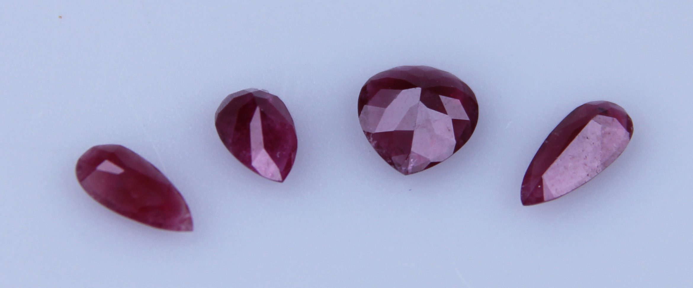 Gemstone Discoveries: Finding a new gemstone! - finding a new gemstone,gems,gemmological discoveries - A group of red beryl pear shaped gemstones