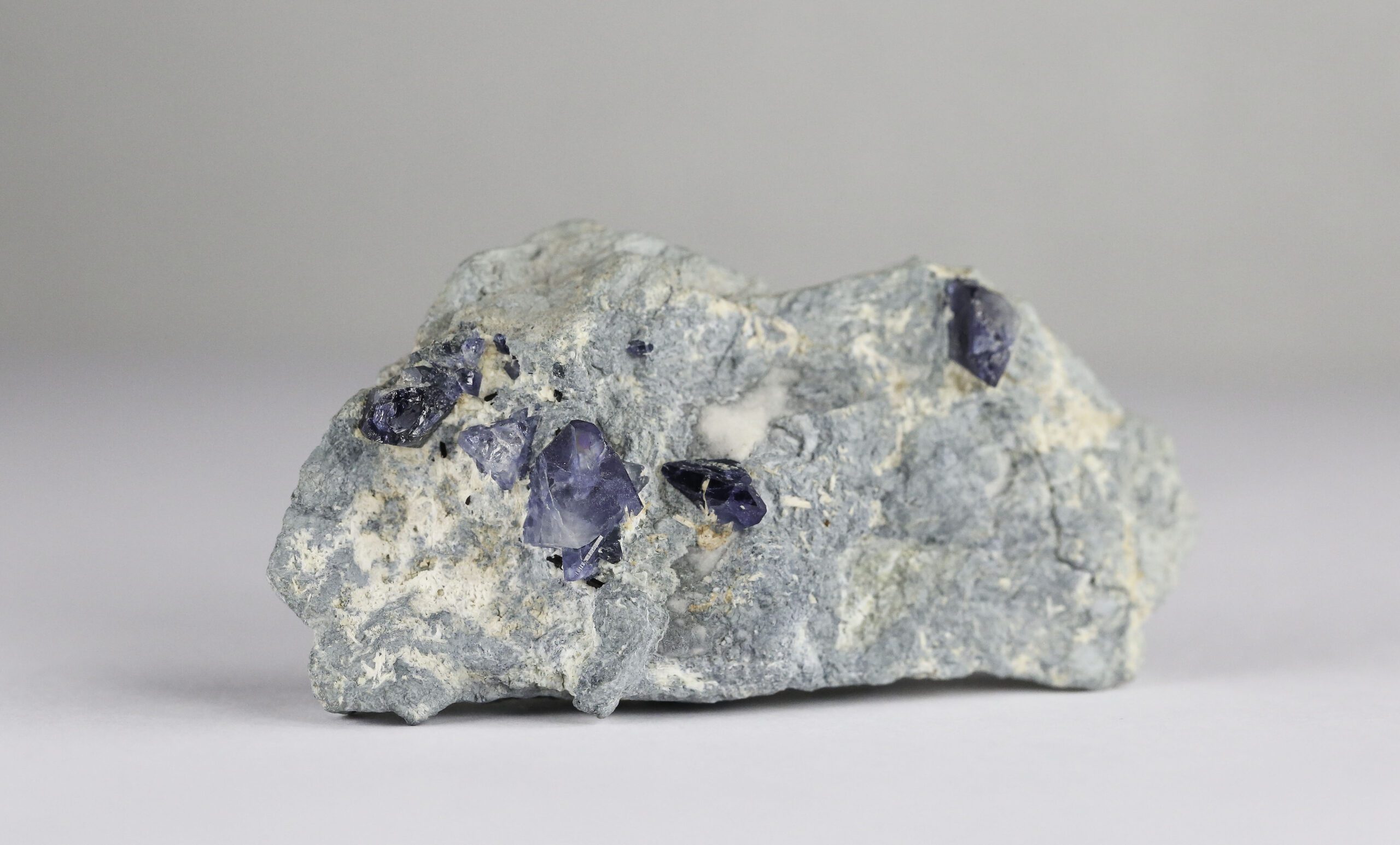 Gemstone Discoveries: Finding a new gemstone! - finding a new gemstone,gems,gemmological discoveries - Benitoite in matrix photographed scaled